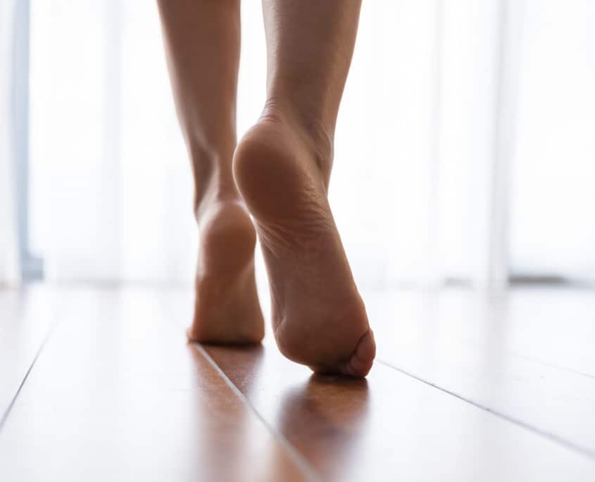 barefoot woman walking indoors