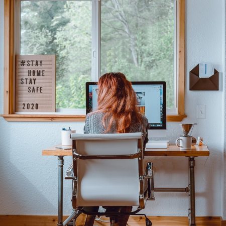girl sitting next to computer